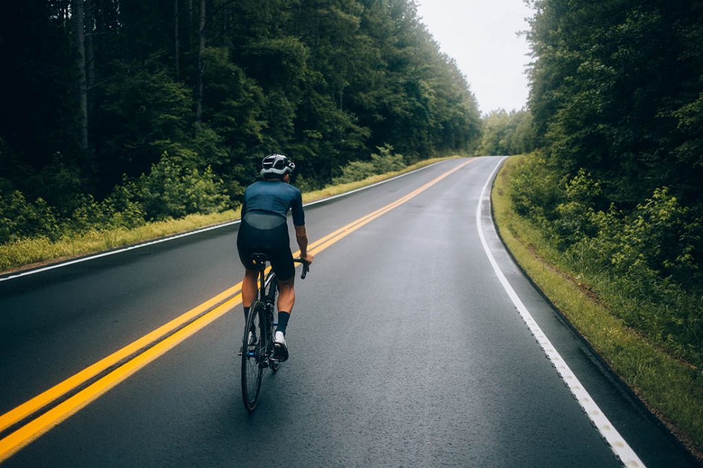 Cyclist man riding a bike on the road go to target for design or decorate cycling sport, business, finance, bangking