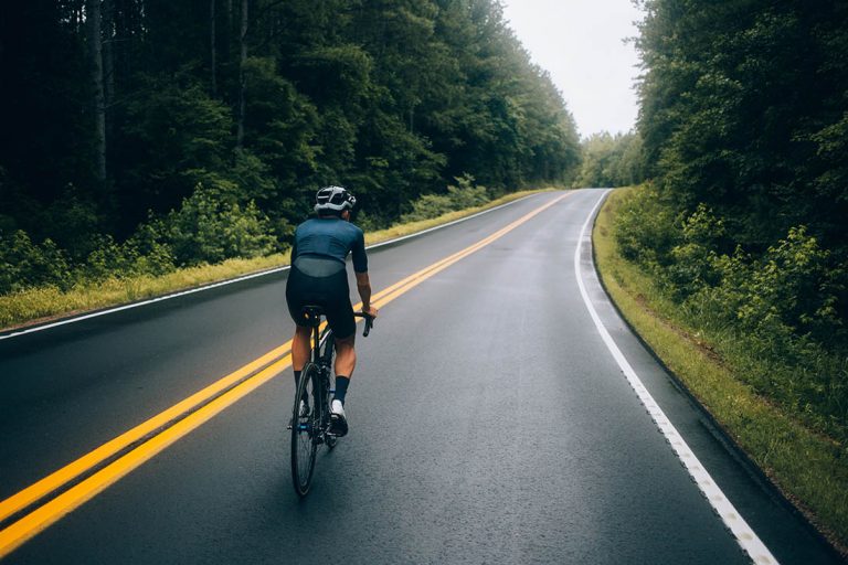 Cyclist man riding a bike on the road go to target for design or decorate cycling sport, business, finance, bangking